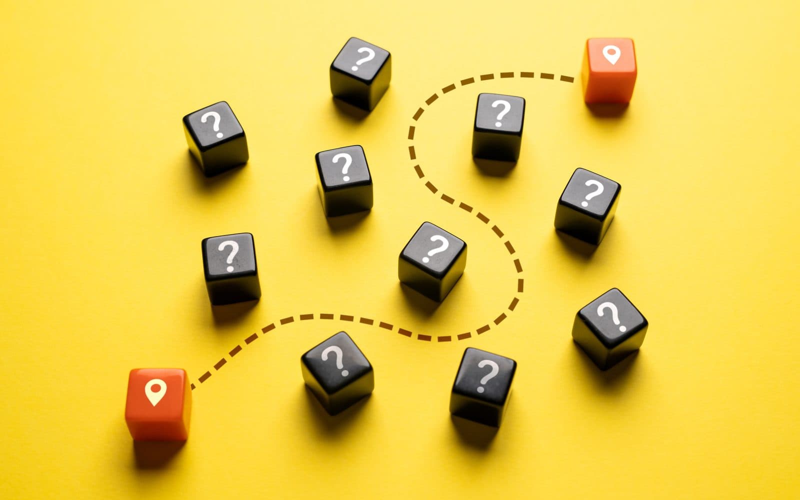 Black dice marked with question marks, with a dashed route running between two orange location pins