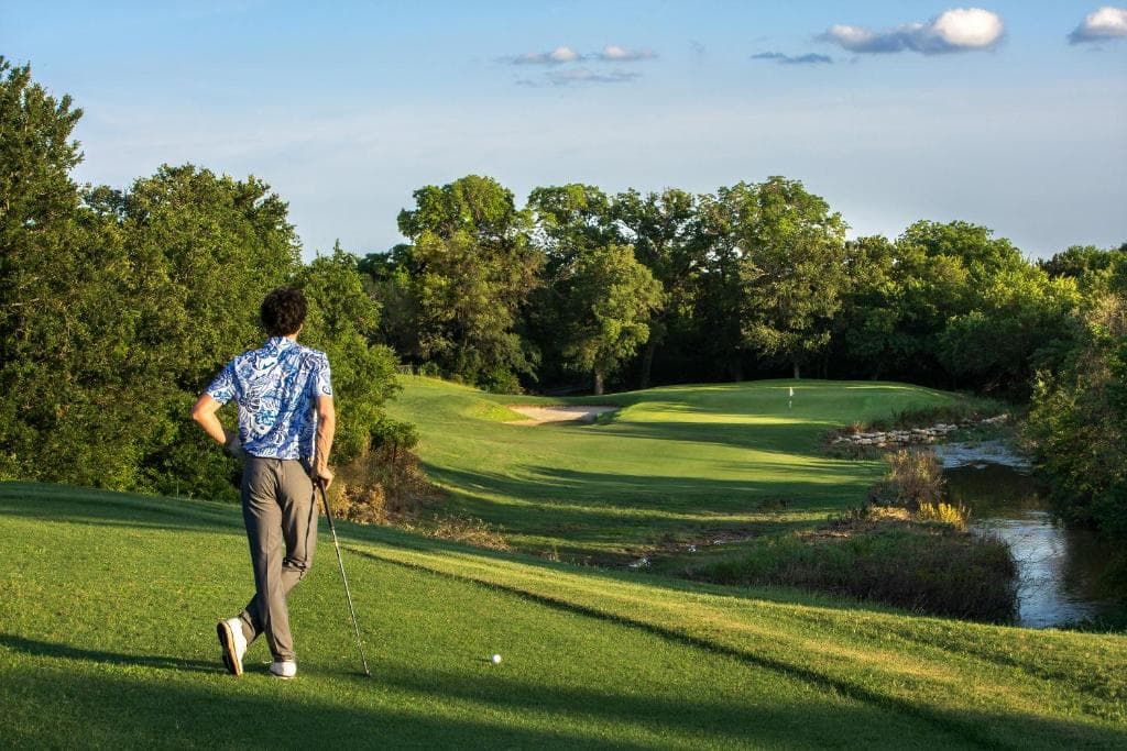 A golfer on the championship course at Champions Circle