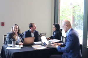 Four real estate agents sit around a table